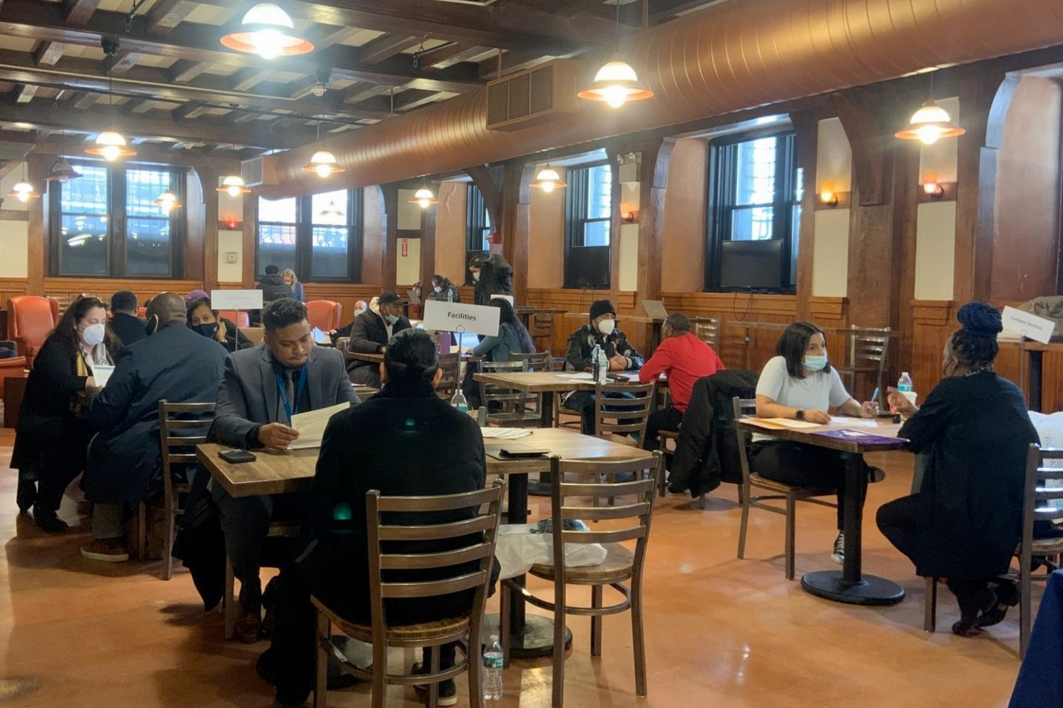 Prospective employees meet with Facilities and Operations HR representatives inside John Jay Hall.