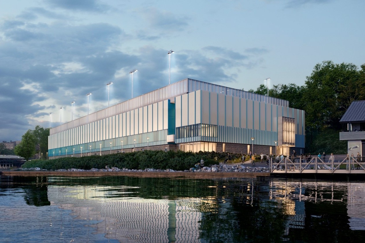 A rendering of the new tennis center, a large rectangular structure alongside the Harlem River.