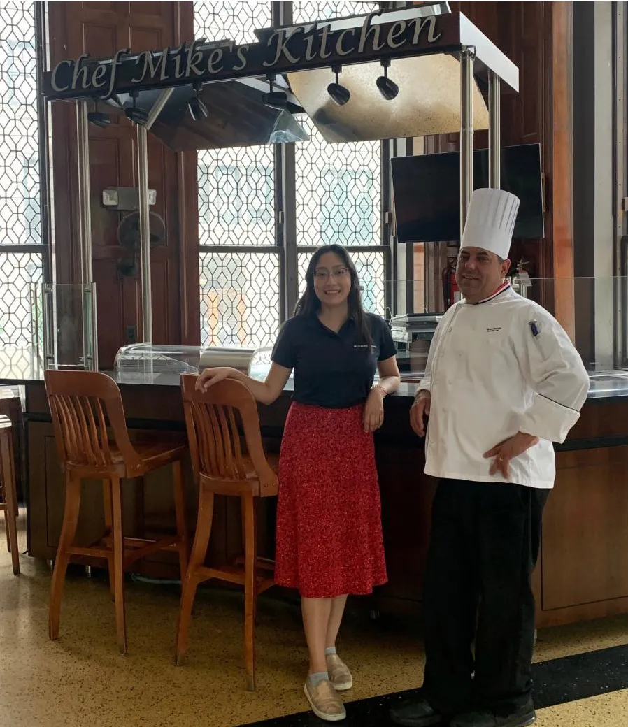 Registered Dietian Alexa Gandara and Chef Mike Martino stand by Chef Mike's Kitchen booth.