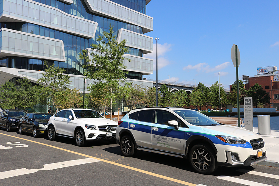 Columbia Mail added Henry R. Kravis Hall and David Geffen Hall to its delivery routes. Columbia Mail's vehicle parked on the street next to Henry R. Kravis Hall.