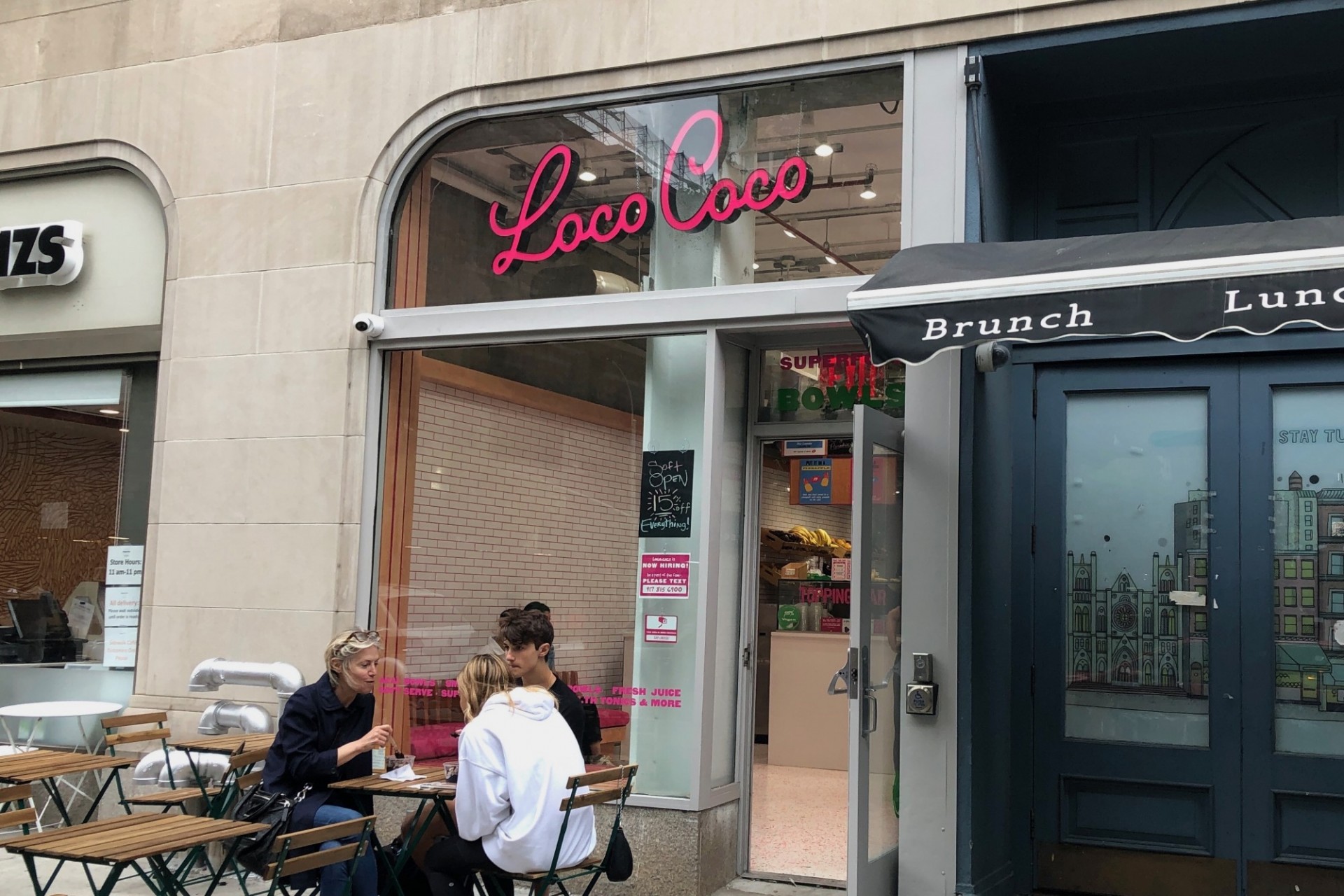 Loco Coco, a vegan superfood cafe, opened at 2905 Broadway. The storefront of Loco Coco, which has a party of three sitting at a table outside.
