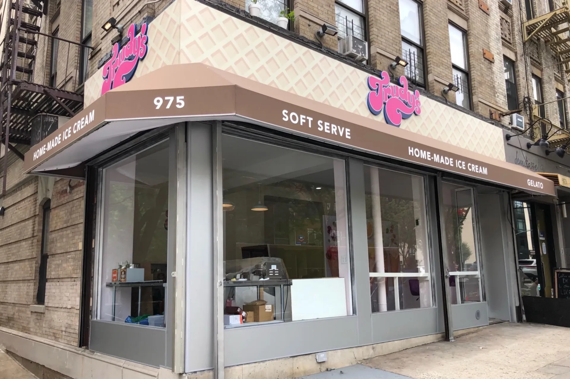 The storefront of Trudy's, which has a cone pattern on the sign and reads, "Trudy's" in bright pink letters.